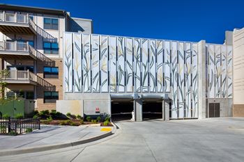 A building with a large mural of palm trees on its side.